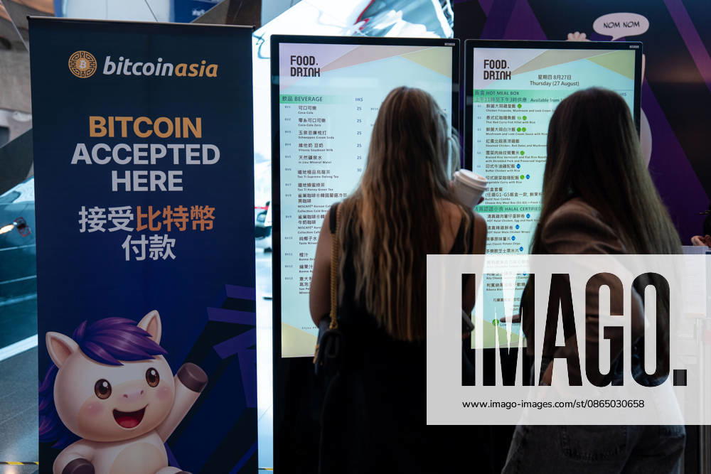 Bitcoin Asia Hong Kong 2026 Two woman looking at a menu next to a sign saying Bitcoin accepted at Bitcoin Asia 2026 on August 27, 2026 in Hong Kong. (Photo by Vernon Yuen Nexpher Images) HONG KONG