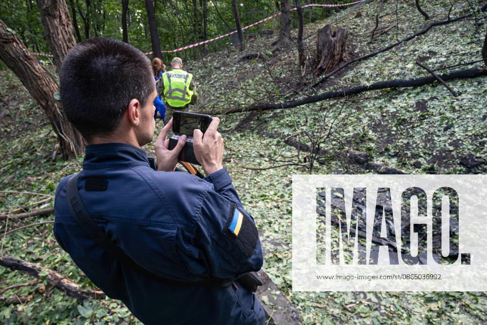 A man takes pictures of fragments of a Russian drone found on Parkova Doroha Street in the Pecherskyi district after a Russian attack, Kyiv, Ukraine, August 27, 2026. Since the night of August 27, the Russian army has been striking the Ukrainian capital with ballistic missiles and drones. Overnight and daytime attacks and falling debris caused destruction across several districts of Kyiv, damaging residential buildings, cars, gymnasium premises and a medical facility. (Photo by Danylo Antoniuk Ukrinform) Forensic experts examine wreckage of Russian drone in Kyiv