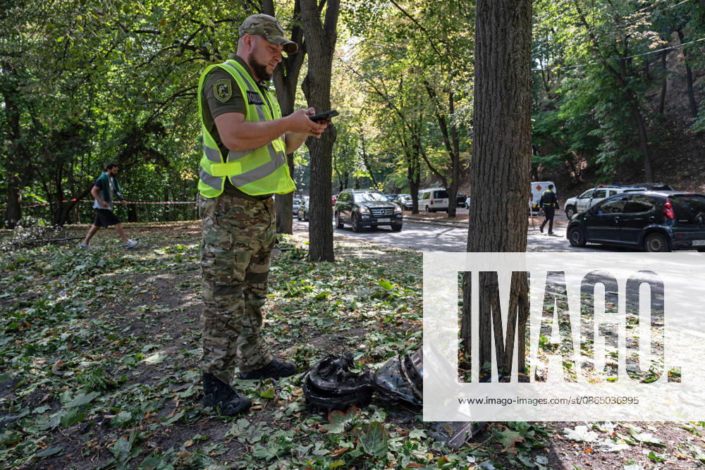 A forensic expert takes pictures of fragments of a Russian drone found on Parkova Doroha Street in the Pecherskyi district after a Russian attack, Kyiv, Ukraine, August 27, 2026. Since the night of August 27, the Russian army has been striking the Ukrainian capital with ballistic missiles and drones. Overnight and daytime attacks and falling debris caused destruction across several districts of Kyiv, damaging residential buildings, cars, gymnasium premises and a medical facility. (Photo by Danylo Antoniuk Ukrinform) Forensic experts examine wreckage of Russian drone in Kyiv
