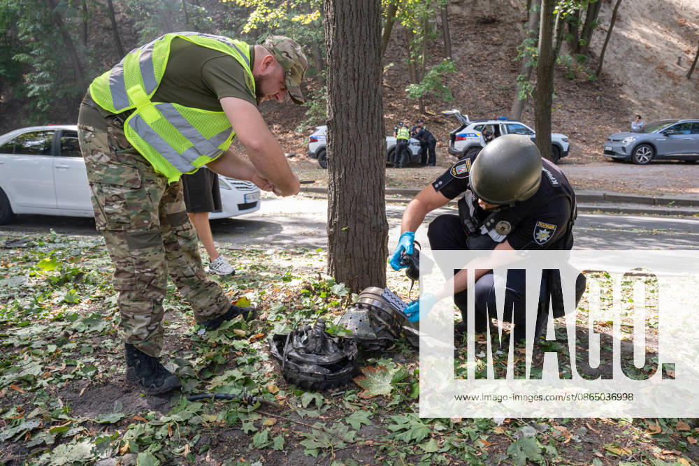 Forensic experts take pictures of fragments of a Russian drone found on Parkova Doroha Street in the Pecherskyi district after a Russian attack, Kyiv, Ukraine, August 27, 2026. Since the night of August 27, the Russian army has been striking the Ukrainian capital with ballistic missiles and drones. Overnight and daytime attacks and falling debris caused destruction across several districts of Kyiv, damaging residential buildings, cars, gymnasium premises and a medical facility. (Photo by Danylo Antoniuk Ukrinform) Forensic experts examine wreckage of Russian drone in Kyiv