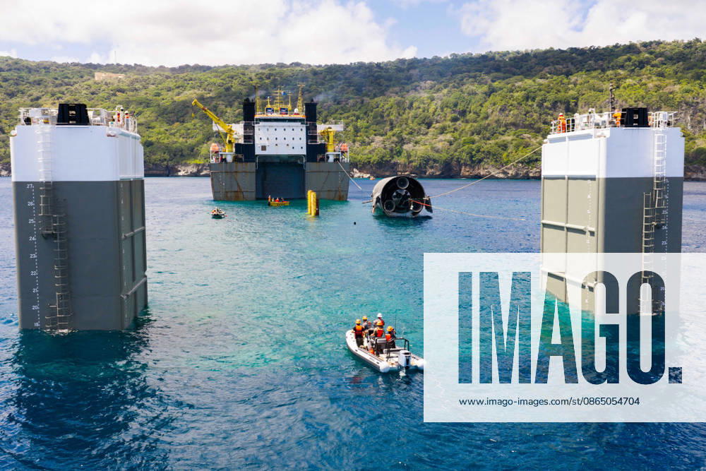 SpaceX engineers spent several days inspecting Ship 40 in the waters off Christmas Island as seen in pictures released on Thursday, August 27, 2026. They collected heatshield samples and gained vital insight into how the vehicle handled reentry, with improvements now planned for future vehicles. Starship has now been loaded onto a semi-submersible ship to begin the several-month journey back to Starbase. WAX2026082705 SPACEX