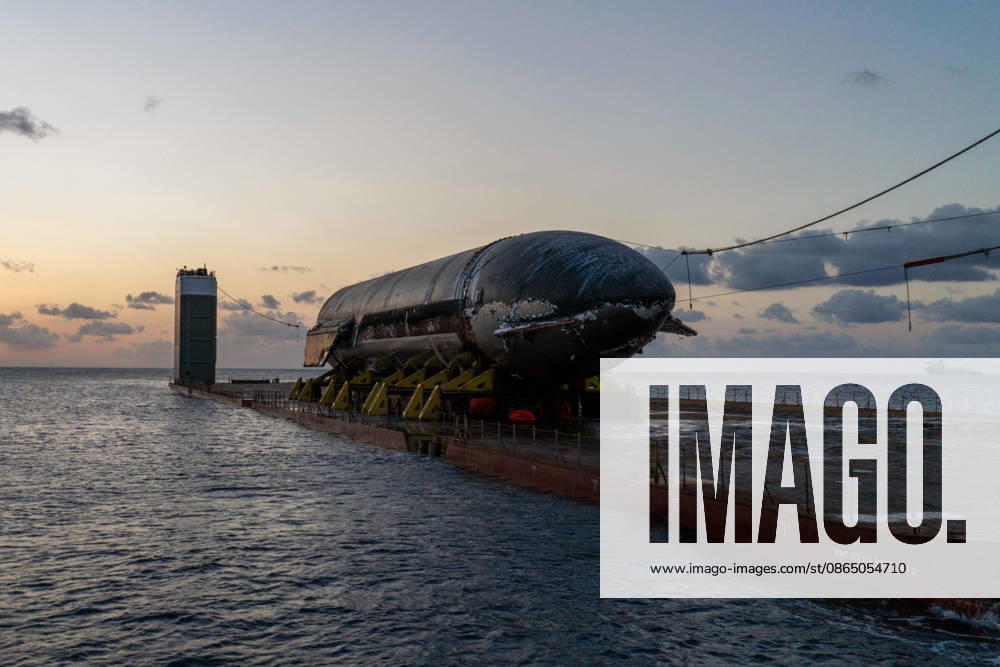 SpaceX engineers spent several days inspecting Ship 40 in the waters off Christmas Island as seen in pictures released on Thursday, August 27, 2026. They collected heatshield samples and gained vital insight into how the vehicle handled reentry, with improvements now planned for future vehicles. Starship has now been loaded onto a semi-submersible ship to begin the several-month journey back to Starbase. WAX2026082708 SPACEX