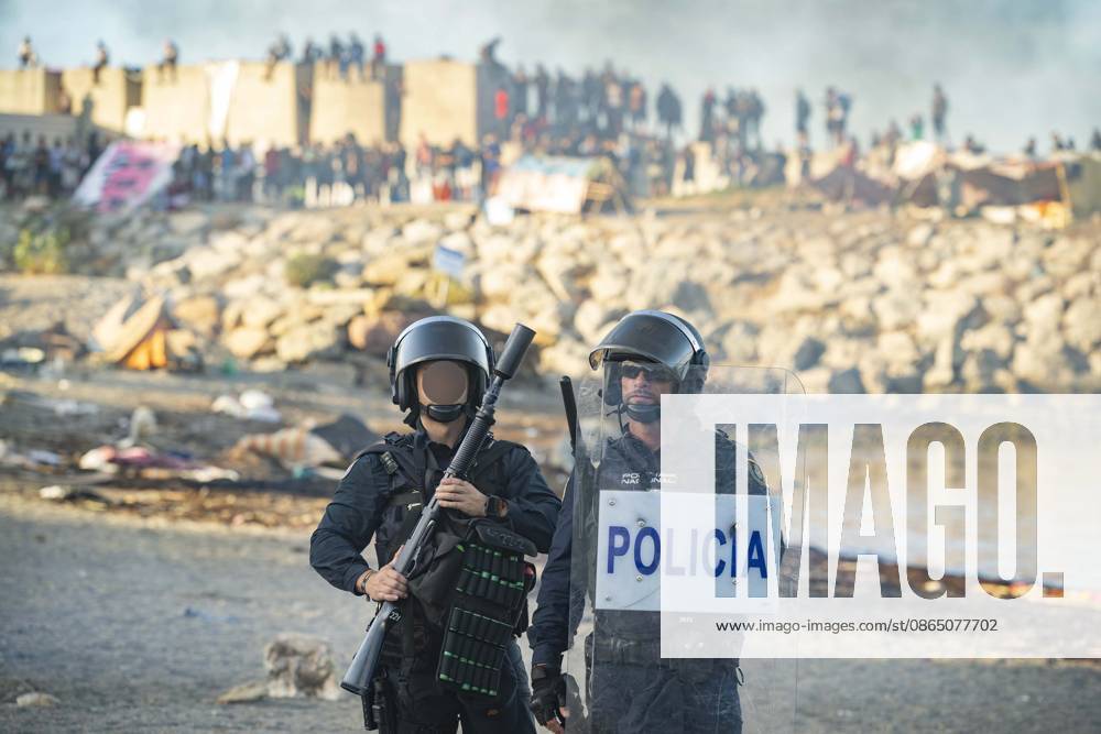 Protest Against Migrants in Ceuta: Police officers during a demonstration protesting the situation caused by the mass arrival of migrants, on August 27, 2026, in Ceuta, Spain. Protesters attempted to block Red Cross volunteers from distributing food bags to migrants on Trampolín Beach and caused disturbances on Benítez Beach in Ceuta, which led to police charges, after they broke into the migrant encampments where people spend the night in the area and caused damage, including the burning of personal belongings. AUGUST 27, 2026 PIXELATED MIGRATION CRISIS Ceuta Ceuta, Spain