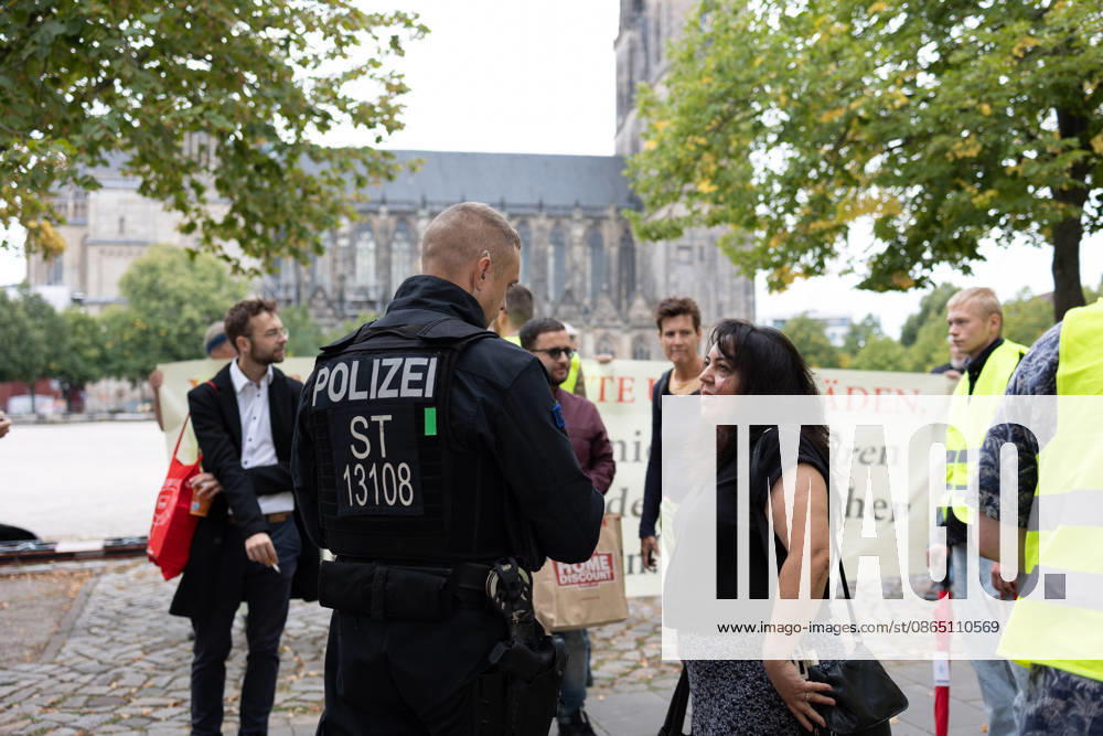 Migra-Streik rally against racism and social exclusion in Germany s Magdeburg MAGDEBURG, GERMANY - AUGUST 27: A police officer speaks with a participant during a rally against racism and social exclusion outside the Saxony-Anhalt state parliament at Domplatz in Magdeburg, Germany, on August 27, 2026. The rally was held as part of the Migra-Streik, during which participating migrant-run businesses across the city voluntarily closed their doors to call for solidarity and the protection of a free and democratic society. Somaya Abdelrahman Anadolu Magdeburg Germany. Editorial use only. Please get in touch for any other usage.