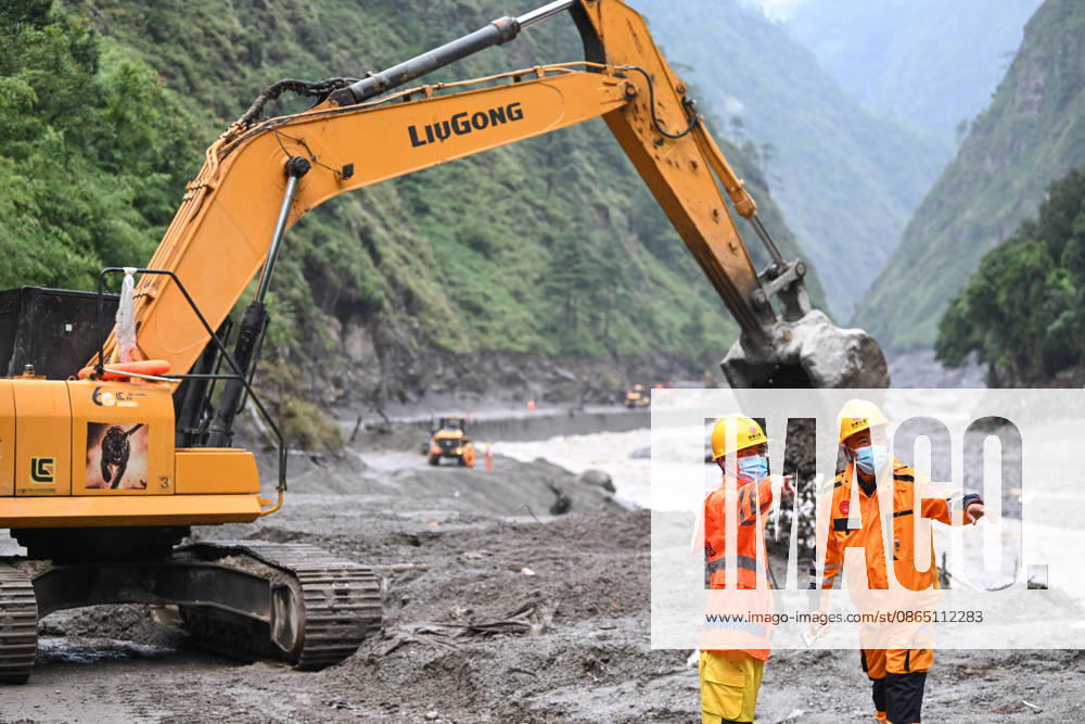 Excavators and loaders clear debris on a damaged road section leading to the Gyirong Port on August 28, 2026 in Gyirong, Xizang Autonomous Region of China. A mudslide occurred on the Nepal side on August 26, causing casualties and missing persons at the port; traffic departments have been working to clear approximately 800 meters of the affected G216 highway section as of August 27.