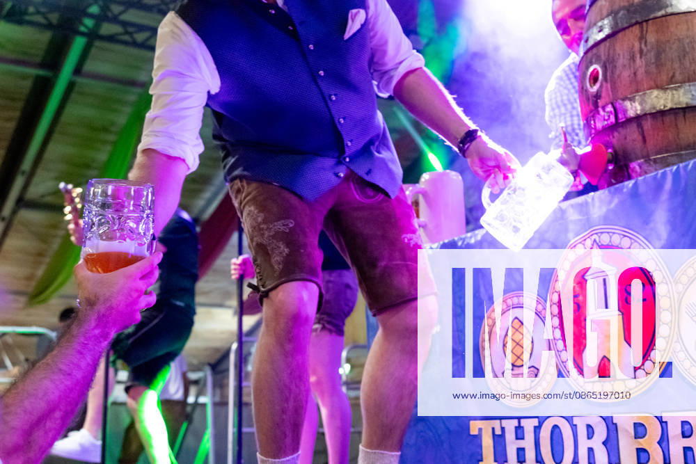 Augsburg, Bavaria, Germany August 28, 2026: Opening of the Plärrer in Augsburg. After the traditional tapping of the keg, free beer is served at the Augsburg Herbstplärrer. Visitors hold out their beer mugs toward the stage and have beer poured directly from the keg