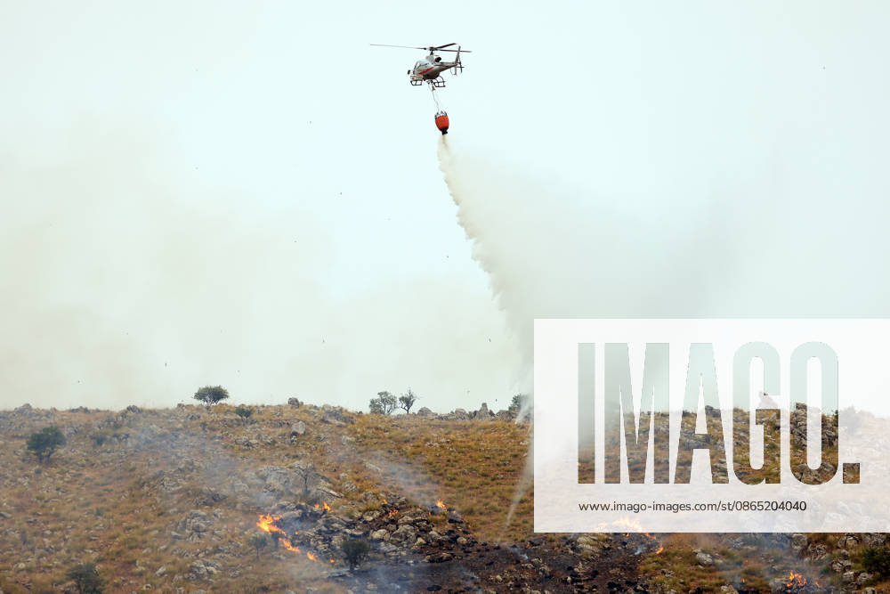 Wildfire suppression efforts continue on Italy s Sicily and Sardinia islands PALERMO, ITALY - AUGUST 28: Firefighting teams and forestry workers respond to tackle a wildfire from the ground with water tankers, while the gendarmerie intervened from the air with a helicopter, in Pianetto, near Palermo, Italy on August 28, 2026. Alberto Lo Bianco Anadolu Palermo Italy. Editorial use only. Please get in touch for any other usage.