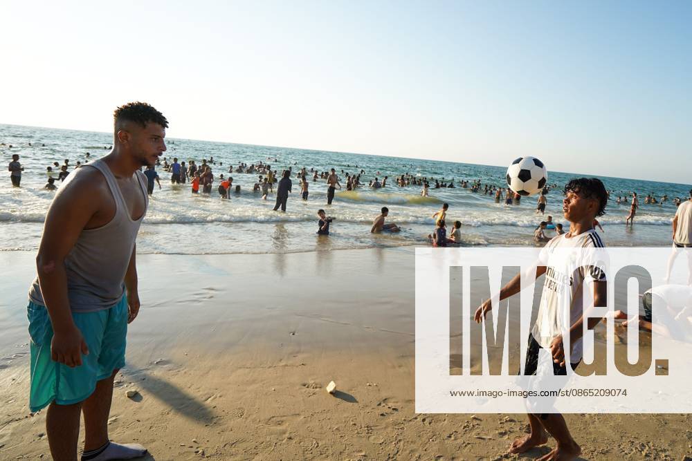 Nuseirat, Palestine, State of: NUSEIRAT, GAZA STRIP, PALESTINE, AUGUST 2026: Palestinians gather along the beach in Nuseirat seeking relief from the summer heat as high temperatures add to difficult living conditions for displaced families staying in tents. Residents spend time by the sea as a respite from the heat and the hardships of daily life in the Gaza Strip. Nuseirat Palestine, State of - ZUMAq101 20260828_zna_q101_165
