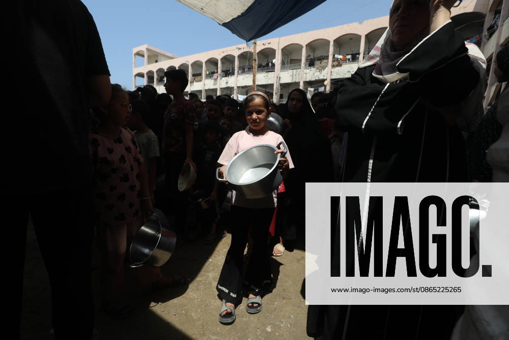 Displaced Palestinians Gather for Food Aid in Northern Gaza Displaced Palestinians carrying pots and containers gather to receive food from a charity kitchen in the northern Gaza Strip on August 29, 2026. Residents continue to face difficult humanitarian conditions and severe shortages of basic necessities amid the ongoing war and its widespread impact on daily life. Photo by Hassan al-Jedi apaimages Nusairat Gaza Strip Palestinian Territory 290826_Gaza_HJ_00(11).jpeg