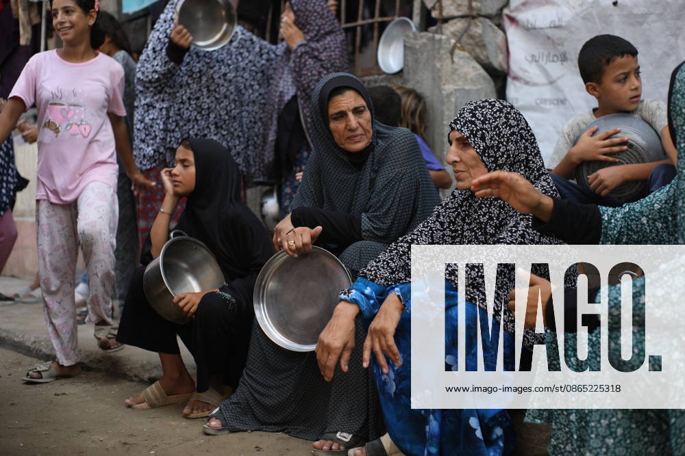 Displaced Palestinians Gather for Food Aid in Northern Gaza Displaced Palestinians carrying pots and containers gather to receive food from a charity kitchen in the northern Gaza Strip on August 29, 2026. Residents continue to face difficult humanitarian conditions and severe shortages of basic necessities amid the ongoing war and its widespread impact on daily life. Photo by Hassan al-Jedi apaimages Nusairat Gaza Strip Palestinian Territory 290826_Gaza_HJ_00(7).jpeg