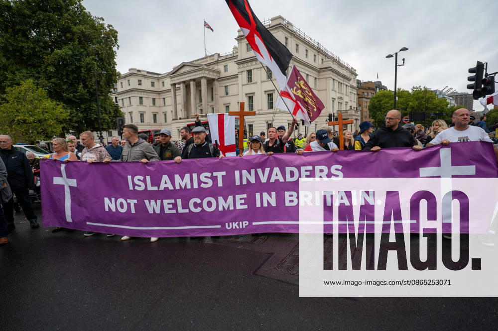 Protestors hold a banner during the No to Sharia Law protest in central London. UKIP leader Nick Tenconi led supporters on a march and rally through central London calling for an end to Sharia law in Great Britain. The demonstration, organized under the banner No to Sharia Law, was met by a counter-protest. Tensions rose at the start of the march, with counter-protesters pushing against police officers as officers attempted to keep the opposing groups apart. The Metropolitan Police had imposed conditions on both demonstrations to prevent serious disorder. London United Kingdom - ZUMAs197 20260829_aaa_s197_177