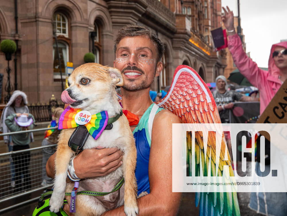 Dog and owner brave the rain during the pride parade. Revelers refused to let a heavy downpour dampen their spirits as the annual parade makes its way through the city centre. Despite the torrential rain, the LGBTQ+ community and supporters partied anyway, filling the streets with vibrant colour, music, and joy. The festival has been officially renamed Manchester Village Pride this year, marking a new community-led chapter after the voluntary liquidation and financial collapse of the former organizing company last autumn. Taking part in the celebrations, the newly elected Mayor of Greater Manchester, Bev Craig, actively engaged with parade participants and cheering crowds along the route through - ZUMAs197 20260829_aaa_s197_351