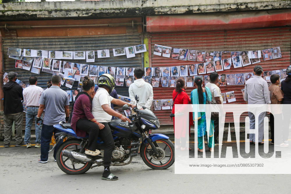 Passersby View Flood Victims Photos - Kathmandu Passersby look at photographs of people who died in the floods, displayed outside a hospital in Kathmandu, Nepal on August 30, 2026. Photo by Sunil Pradhan ABACAPRESS.COM Kathmandu Bagmati Nepal