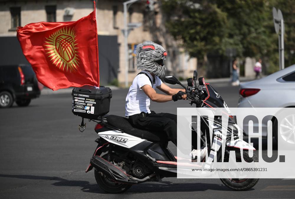 Kyrgyzstan SCO Summit Preparations 9231717 31.08.2026 A motorcyclist on a scooter carrying the Kyrgyz flag rides along a street in Bishkek, Kyrgyzstan. The Shanghai Cooperation Organization (SCO) summit will be held in the Kyrgyz capital from August 31 to September 1. Kristina Solovyova Sputnik Bishkek Kyrgyzstan
