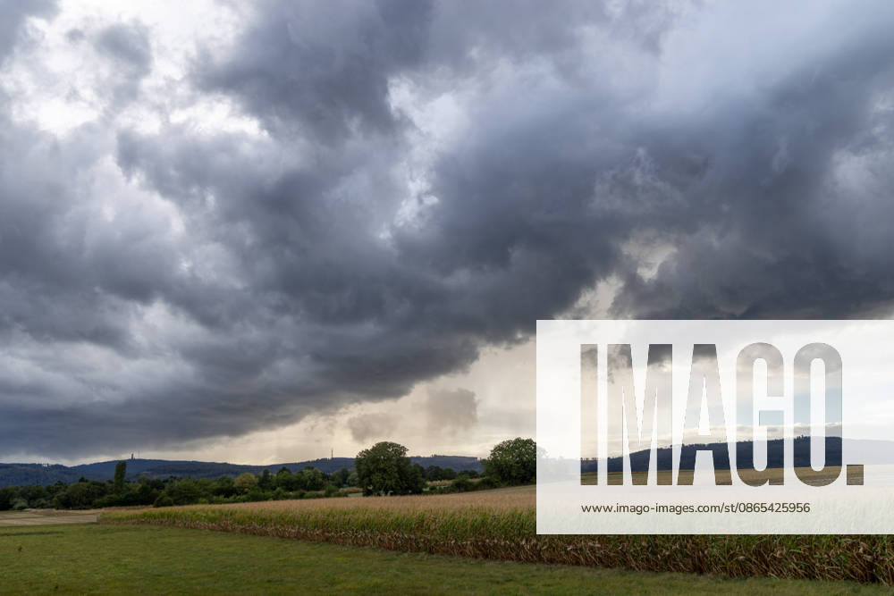 Showery weather in late summer: Dark clouds from a shower are visible in the evening sky over the Taunus Mountains, Oberursel, Hesse, Germany