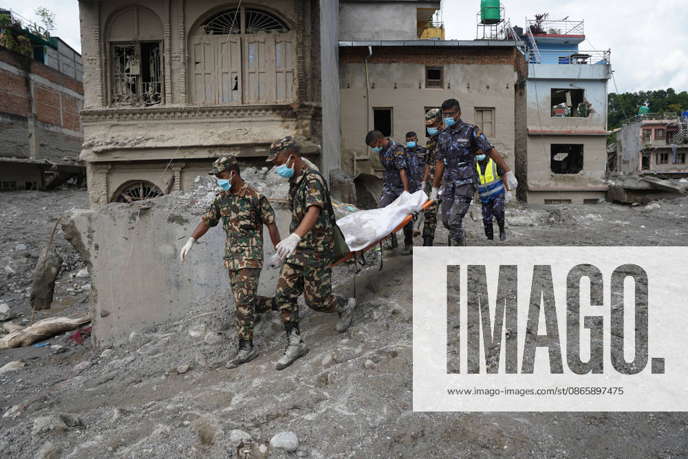Following the devastating floods in Nepal, personnel from the Nepal Army and Nepal Police are carrying body on stretcher through the disaster-affected areas, navigating past flood-damaged houses and debris. Nuwakot Nepal - ZUMAa308 20260904_znp_a308_005