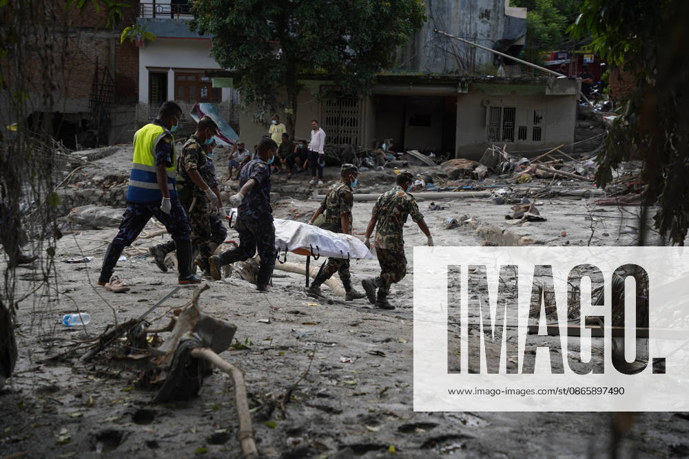 Following the devastating floods in Nepal, personnel from the Nepal Army and Nepal Police are carrying body on stretcher through the disaster-affected areas, navigating past flood-damaged houses and debris. Nuwakot Nepal - ZUMAa308 20260904_znp_a308_007