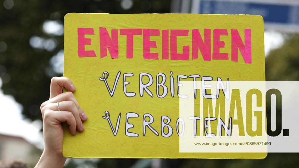 Rent Protest: A protester holding a sign reading Expropriate, Banning Is Banned during a demonstration against high rents and gentrification and in favor of expropriating housing cooperatives; thousands of people protested in Berlin, September 5, 2026, Berlin, Berlin, Germany