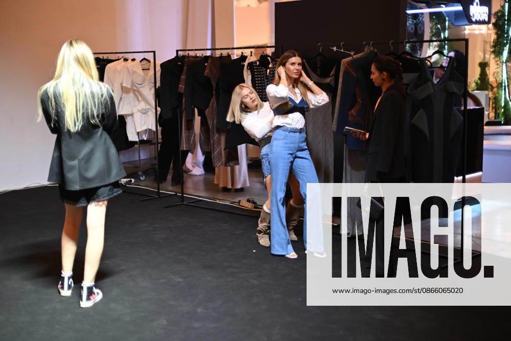 A woman tries on a garment during Ukrainian Fashion Week SS27 at the Mystetskyi Arsenal National Cultural, Art and Museum Complex, Kyiv, Ukraine, September 5, 2026. (Photo by Yevhen Kotenko Ukrinform) Guests visit Ukrainian Fashion Week SS27 in Kyiv