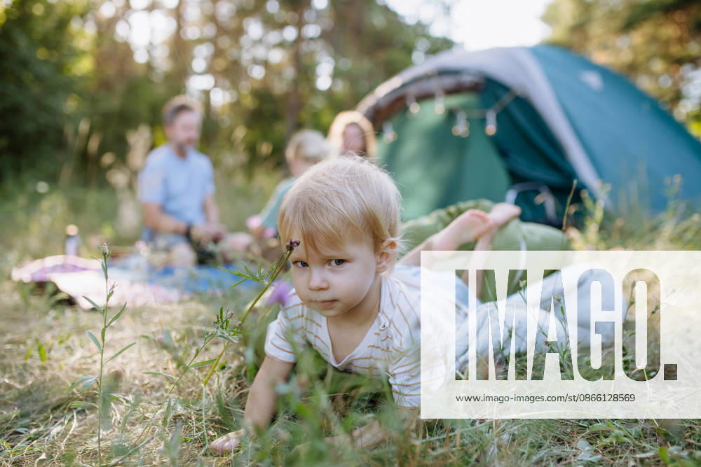 Happy family spending time together during summer camping trip. Happy parents and children bonding during camping adventure. model released