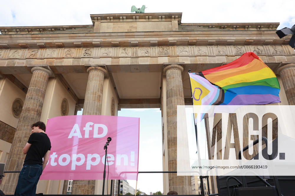 A rainbow flag and a Stop the AfD banner hang in front of the starting point of a rally with the slogan Time to Act, Stop the AfD in Berlin in front of the Brandenburg Gate, Platz des 18 Maer