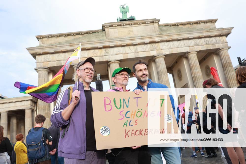 Participants hold a cardboard sign reading Colorful is better than shitty brown at the start of a rally with the slogan Time to Act: Stop the AfD in front of the Bra