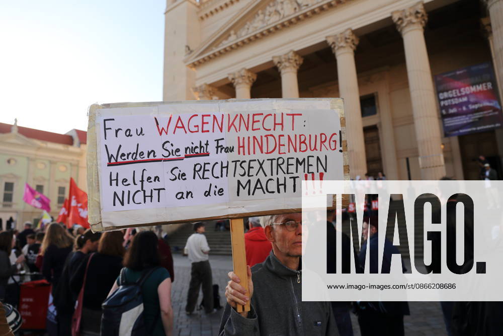 A protester holding a sign reading Ms. Wagenknecht, don’t become Ms. Hindenburg—don’t help the far right come to power during a rally against the Alternative for Germany (AfD) party following its victory in the state election in Saxony-Anhalt, Alter Markt, Potsdam, September 7, 2026. Rally against the AfD in Potsdam