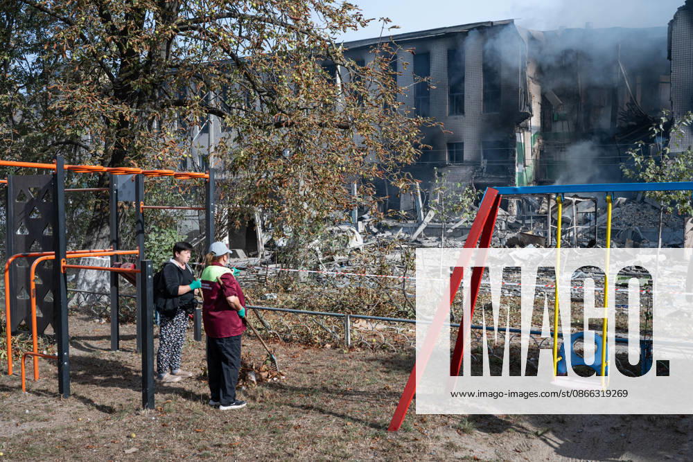 A municipal worker standing in a playground with a rake faces a building damaged by a Russian attack in the Solomianskyi district, Kyiv, Ukraine, September 8, 2026. On Tuesday night, September 8, Russian forces launched another massive strike on the Ukrainian capital with ballistic and cruise missiles, as well as jet UAVs. The attack caused significant damage to civilian infrastructure, residential areas, and business facilities. Three people were killed, and 19 were injured. (Photo by Danylo Antoniuk Ukrinform) Destruction and fires reported across Kyiv districts after Russian attack