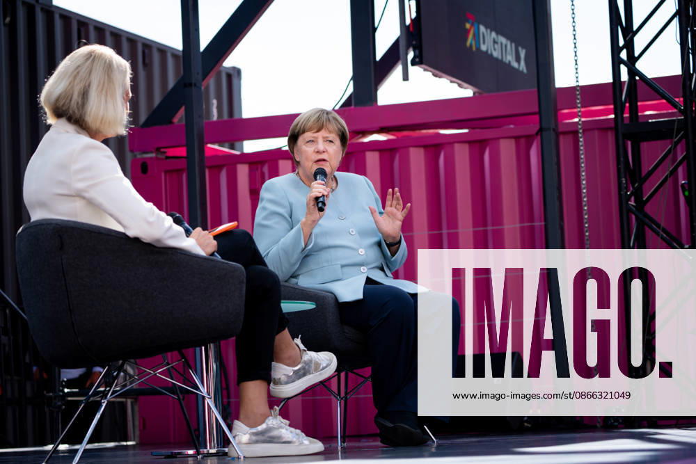 Digital X 2026: Dr. Angela Merkel, former German Chancellor, gesturing and holding a microphone, alongside Prof. Dr. Miriam Meckel,