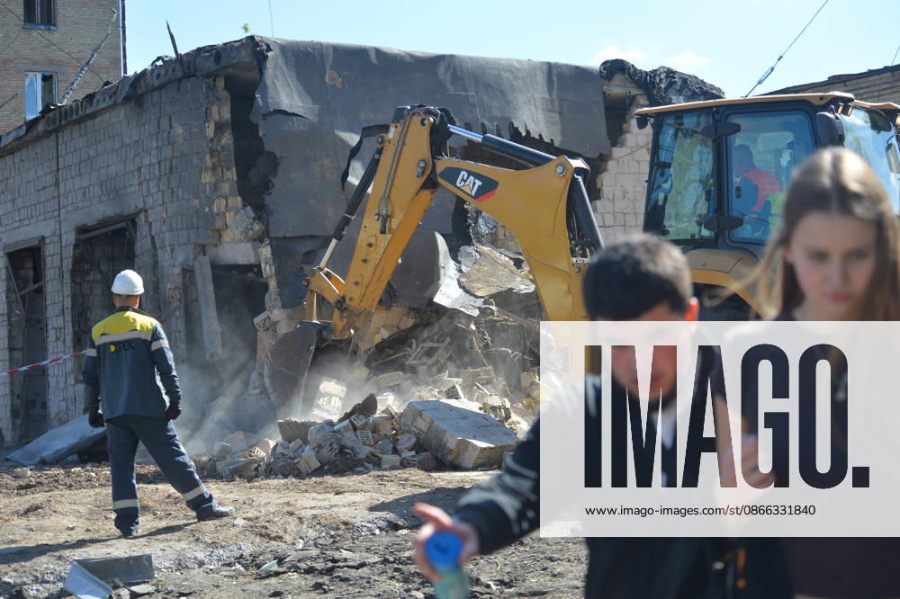 An employee of an electric company watches a backhoe loader remove the rubble as young people walk past in the Solomianskyi district after a Russian attack, Kyiv, Ukraine, September 8, 2026. On Tuesday night, September 8, Russian forces launched another massive strike on the Ukrainian capital with ballistic and cruise missiles, as well as jet UAVs. The attack caused significant damage to civilian infrastructure, residential areas, and business facilities. Three people were killed, and 19 were injured. (Photo by Oleksandr Klymenko Ukrinform) Destruction and fires reported across Kyiv districts after Russian attack