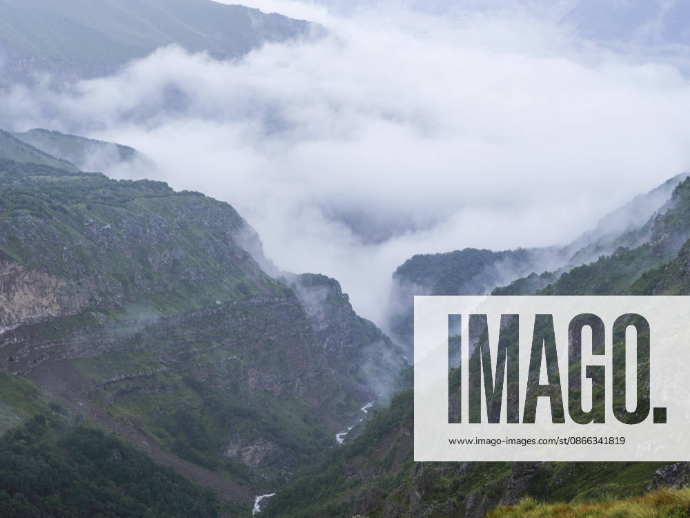 Caucasus Mountains Georgia Expedition A view shows a deep mountain gorge filled with low-hanging clouds close to the Dariali Gorge in the Caucasus Mountains near Stepantsminda, Georgia, on August 31, 2026. Mount Kazbek, a 5,054-meter-high extinct stratovolcano in the Caucasus Mountains along the border between Georgia and Russia, is a premier destination for international trekkers and mountaineers. The nearby town of Stepantsminda and landmarks such as the 14th-century Gergeti Trinity Church and the Soviet-era Bethlemi Hut serve as critical staging and acclimatization areas for high-altitude expeditions facing volatile alpine weather. Stepantsminda Mtskheta-Mtianeti Georgia