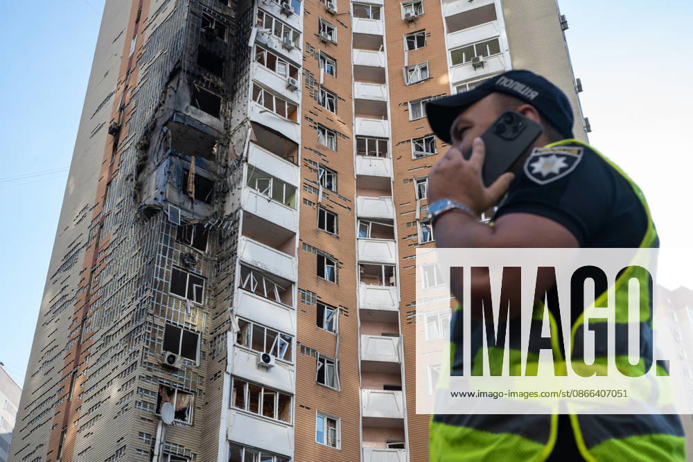 A National Police officer in a high-visibility vest talks on the phone outside a 24-storey apartment block damaged by a Russian attack in the Darnytskyi district of Kyiv, Ukraine, September 9, 2026. On Wednesday morning, September 9, a Russian drone hit the 24-storey building on the 12th floor. According to police, five people were injured, including a pregnant woman. (Photo by Danylo Antoniuk Ukrinform) Apartment block hit by Russian drone in Kyiv