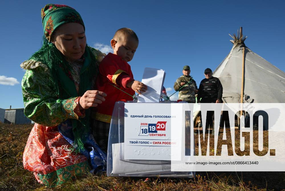 Russia Parliamentary Election Early Voting 9239456 09.09.2026 A member of a local indigenous community with a child casts her ballot during the early voting in remote areas ahead of State Duma elections at a reindeer camping ground, in Yamalo-Nenets Autonomous Area, Russia. Russians will vote in State Duma, the lower house of parliament, and municipal elections over three days, from September 18-20. Alexandr Kryazhev Sputnik Yamalo-Nenets Autonomous Area Russia