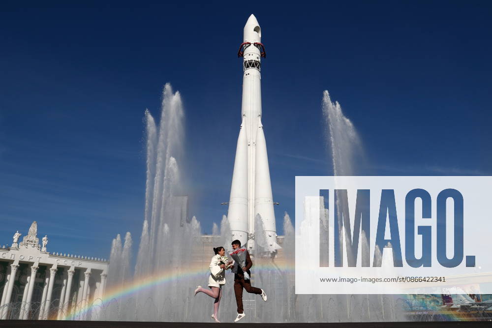 A couple stands beneath a Vostok carrier rocket mock-up at a newly renovated fountain in Industry Square at the VDNKh exhibition centre. Moscow Russia - ZUMAt113 20260909_zaa_t113_017