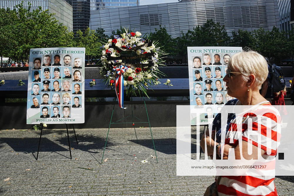 Visitors look over a memorial and flower arrangement to the NYPD along the South Tower reflecting pool ahead of the 25th anniversary of the attacks of September 11 at the 9 11 Memorial on September 9, 2026 in New York. New York USA - ZUMAb148 20260909_zap_b148_032