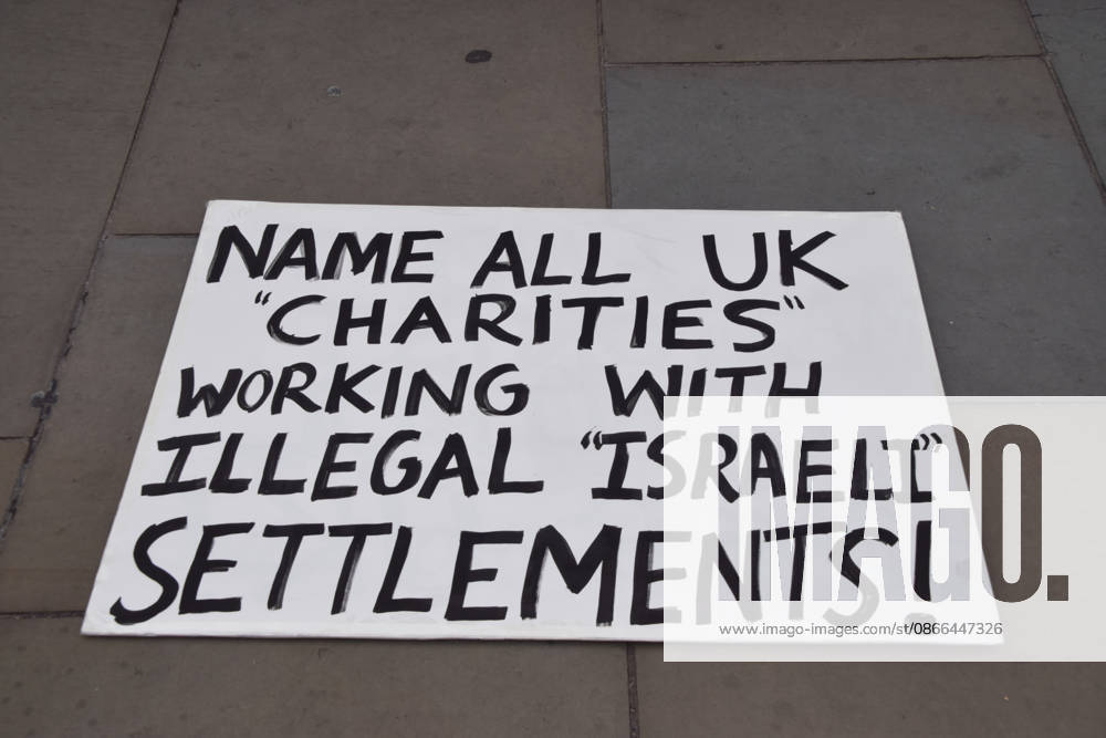 A placard calls for the naming of all UK charities working with illegal Israeli settlements as protesters gather in Parliament Square in support of Palestine and against what the protesters call a pro-Israel and Zionist influence in UK politics. London United Kingdom - ZUMAv130 20260909_zip_v130_098