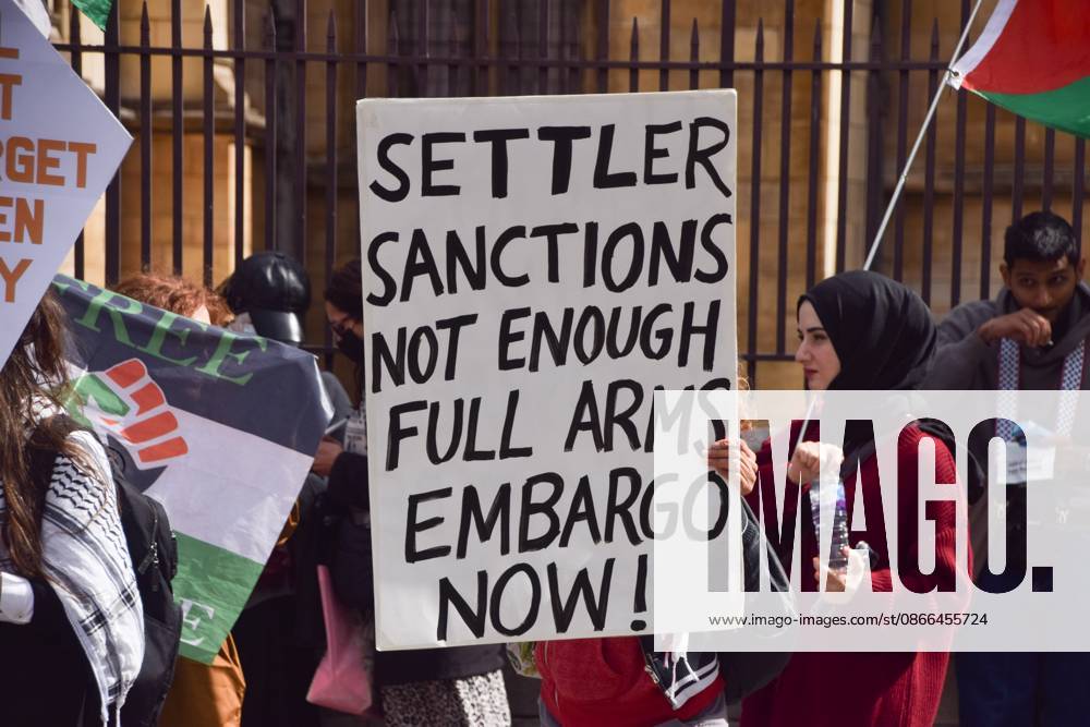 Pro-Palestine protest in London, UK - 9 Sep 2026 A protester holds a placard stating Settler sanctions not enough, full arms embargo now during the demonstration. Protesters gathered in Parliament Square in support of Palestine and against what the protesters call a pro-Israel and Zionist influence in UK politics. London United Kingdom