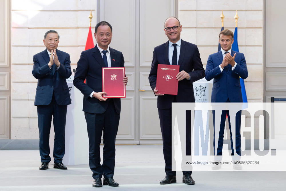 French Deputy Minister of Industry Sébastien Martin and Tran Hong Thai, President of the Vietnamese Academy of Science and Technology, flanked by French President Emmanuel Macron and Vietnamese President To Lam, exchange signed documents regarding a declaration of intent on an Earth observation satellite between France and Vietnam at the Élysée Palace in Paris on September 10, 2026 Raphael Lafargue Pool Bestimage Paris, France