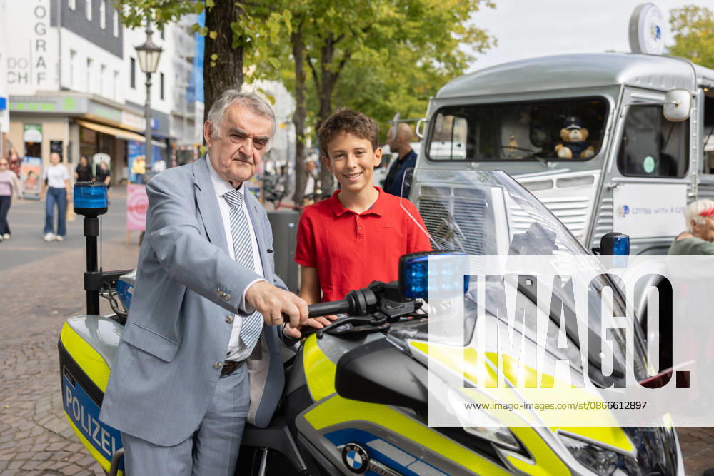 Coffee with a Cop in Siegburg, September 11, 2026: Birthday photo of Maximilian, now 12 years old, with the Minister of the Interior on a motorcycle. As part of the nationwide police initiative Coffee with a Cop, North Rhine-Westphal