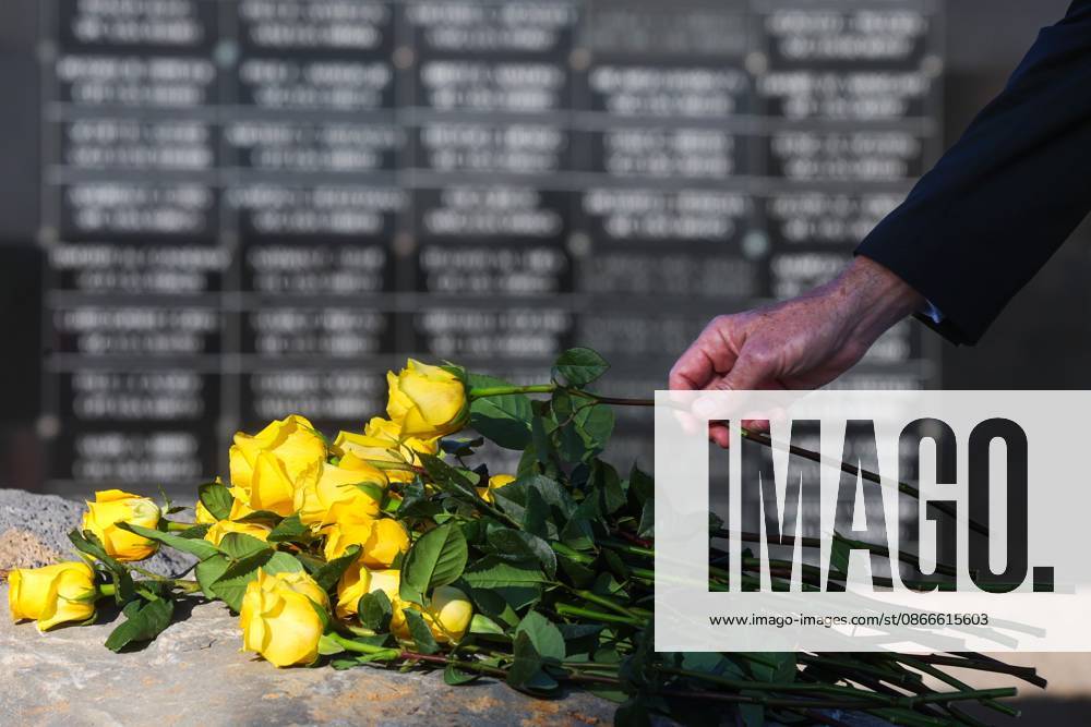 Members of the military community and guests lay flowers at the foot of the memorial with the dedicated wall honoring roughly 1,900 fallen special operations service members pictured in the background during the flower tribute at the end of the 9 11 25th Anniversary Memorial Service hosted by U.S. Special Operations Command (USSOCOM) to honor the 25th anniversary of the Sept. 11 terrorist attacks at the MacDill AFB Special Operations Forces Memorial on Friday, Sept. 11, 2026 in Tampa. Tampa USA - ZUMAs70_ 20260911_zan_s70_012