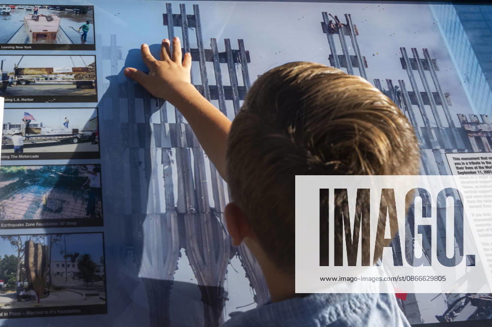 A boy examines a 9 11 memorial display featuring images of the World Trade Center site as the Los Angeles Fire Department marks the 25th anniversary of the terrorist attacks at the Frank Hotchkin Memorial Training Center in Los Angeles, California, on Sept. 11, 2026. Los Angeles USA - ZUMAc68_ 20260911_zaf_c68_012