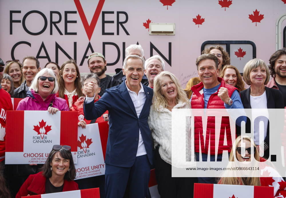 Prime Minister Mark Carney, centre left, volunteer Fran Milburn, centre, and Forever Canadian founder Thomas Lukaszuk, centre right, pose for a group photo with volunteers following a cabinet retreat in Banff, Alta., Friday, Sept. 11, 2026. Banff CANADA - ZUMAc35_ 20260911_zaf_c35_116
