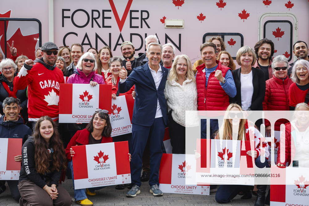 Prime Minister Mark Carney, centre left, volunteer Fran Milburn, centre, and Forever Canadian founder Thomas Lukaszuk, centre right, pose for a group photo with volunteers following a cabinet retreat in Banff, Alta., Friday, Sept. 11, 2026. Banff CANADA - ZUMAc35_ 20260911_zaf_c35_117