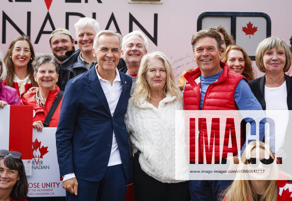 Prime Minister Mark Carney, centre left, volunteer Fran Milburn, centre, and Forever Canadian founder Thomas Lukaszuk, centre right, pose for a group photo with volunteers following a cabinet retreat in Banff, Alta., Friday, Sept. 11, 2026. Banff CANADA - ZUMAc35_ 20260911_zaf_c35_118