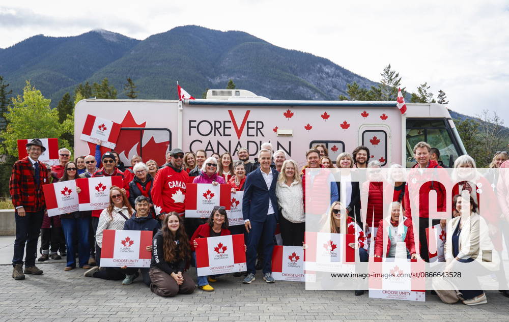 Prime Minister Mark Carney, centre left, volunteer Fran Milburn, centre, and Forever Canadian founder Thomas Lukaszuk, centre right, pose for a group photo with volunteers following a cabinet retreat in Banff, Alta., Friday, Sept. 11, 2026. Banff CANADA - ZUMAc35_ 20260911_zaf_c35_122