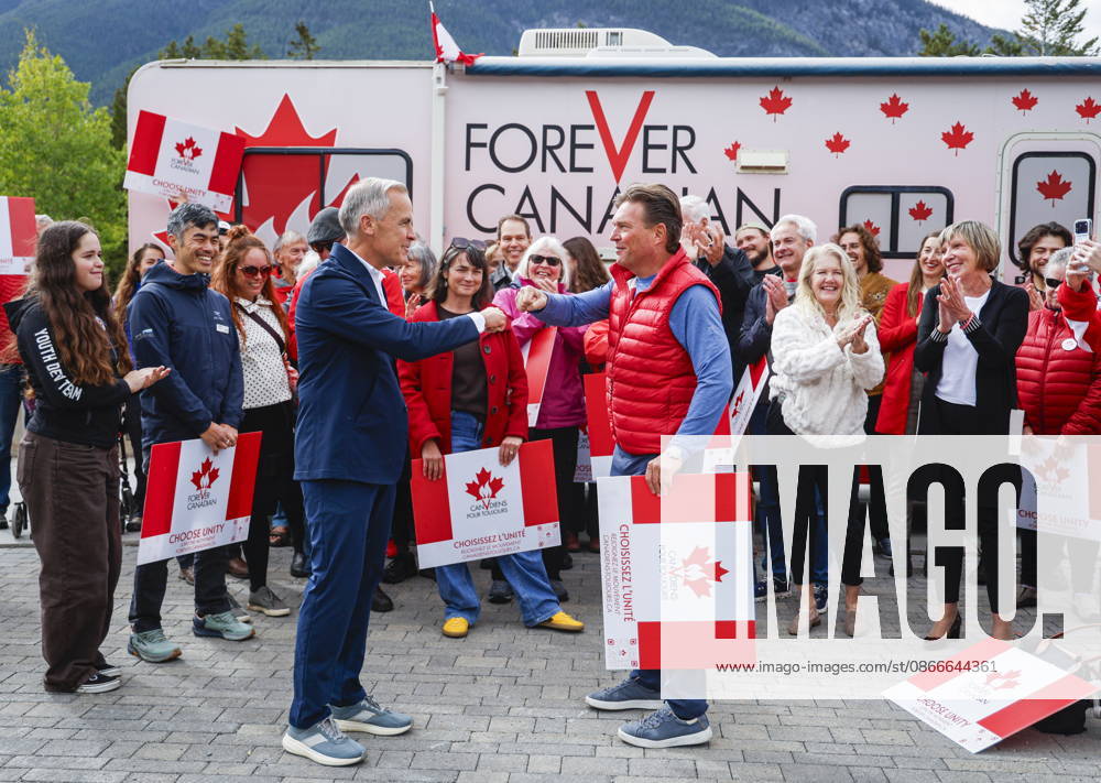 Prime Minister Mark Carney, centre left, and Forever Canadian founder Thomas Lukaszuk, centre right, bump fists after posing for a group photo with volunteers following a cabinet retreat in Banff, Alta., Friday, Sept. 11, 2026. Banff CANADA - ZUMAc35_ 20260911_zaf_c35_127