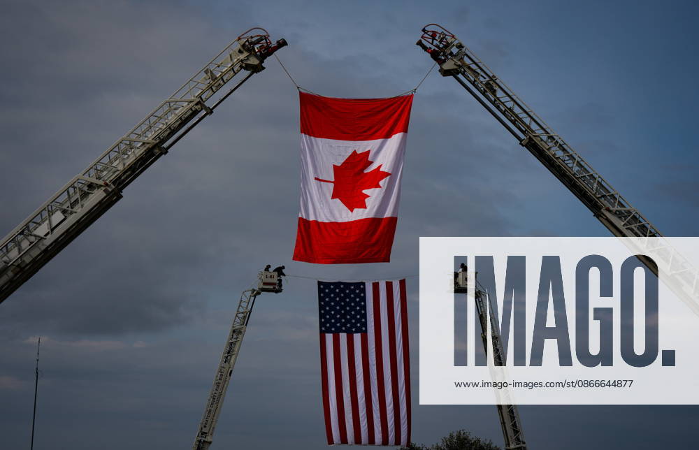 A Canadian flag flies between ladders on fire trucks as firefighters secure a U.S. flag in the same fashion before the Northwest 9 11 Memorial ceremony at the Peach Arch monument on the Canada-U.S. border between Surrey, B.C., and Blaine, Wash., in Surrey, B.C., on Friday, Sept. 11, 2026. Surrey CANADA - ZUMAc35_ 20260911_zaf_c35_128