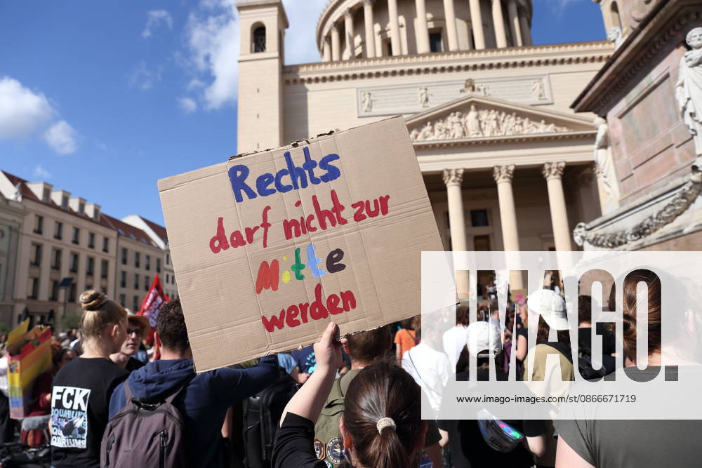 A female protester holding a sign that reads The Right Must Not Become the Center during a demonstration calling for the Federal Constitutional Court to review far-right parties, Alter Markt, Potsdam, September 12, 2026—Protest in Potsdam