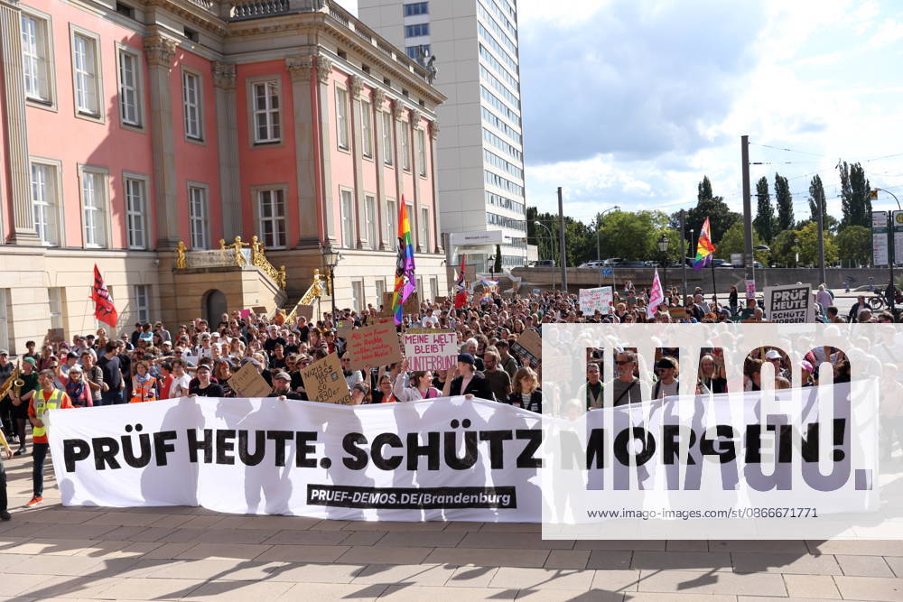 Protesters carrying a banner reading Review today, Schütz tomorrow march around the state parliament during a demonstration calling for the Federal Constitutional Court to review far-right parties, Alter Markt, Potsdam, September 12, 2026. Review demonstration in Potsdam