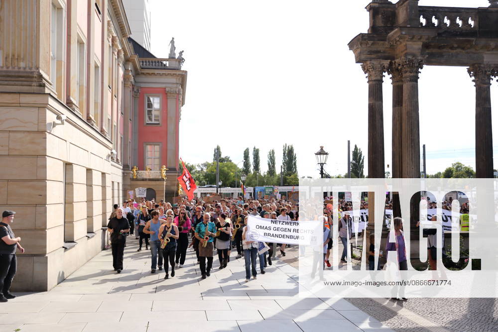 Protesters march around the state capitol building carrying a banner reading Netzwerk Omas gegen Rechts Brandenburg during a demonstration calling for the Federal Constitutional Court to review far-right parties, Alter Markt, Potsdam, September 12, 2026. Protest in Potsdam
